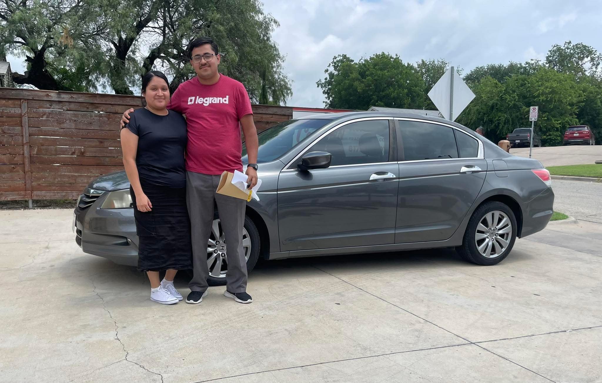 Cowtown Auto Group customers with their new car on the lot in Fort Worth